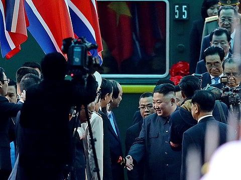 North Korean leader Kim Jong Un, center right, is welcomed upon arrival by train, back, in Dong Dang in Vietnamese border town 