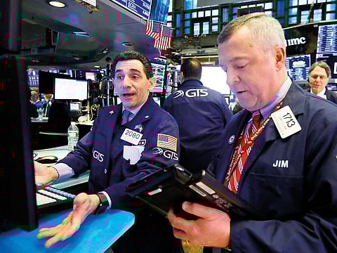Traders work on the floor of the New York Stock Exchange. 