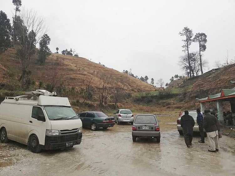 Pakistani reporters wait for a permission