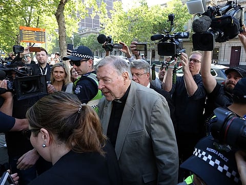 Cardinal George Pell makes his way through media as he arrives at court in Melbourne on February 27, 2019.