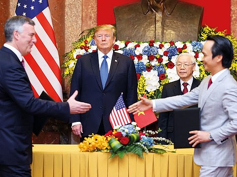 Boeing Commercial Airplanes CEO Kevin McAllister with Chairman of Bamboo Airways Trinh Van Quyet as US President Donald Trump and his Vietnamese counterpart Nguyen Phu Trong look on in Hanoi on Wednesday.