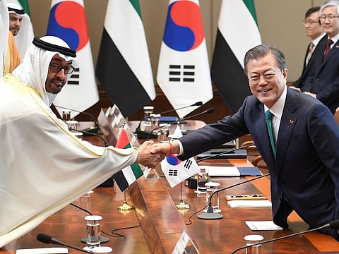 South Korean President Moon Jae-In (R) shakes hands with Abu Dhabi's Crown Prince Sheikh Mohammed Bin Zayed Al Nahyan during a meeting at the presidential Blue House on February 27, 2019 in Seoul, South Korea.