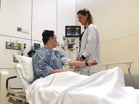 A doctor checking on a patient at the Emergency Department at Cleveland Clinic in Abu Dhabi.