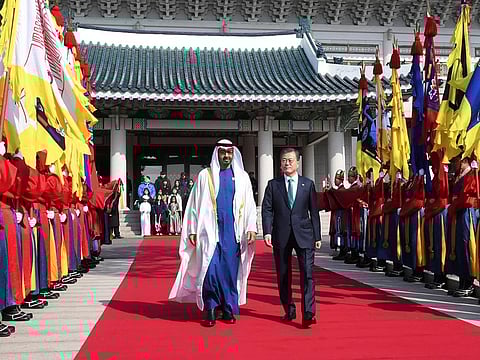 South Korean President Moon Jae-In (R) and Abu Dhabi's Crown Prince Sheikh Mohammed Bin Zayed Al Nahyan  walk towards a guard of honour during a welcoming ceremony at the presidential Blue House on February 27, 2019 in Seoul, South Korea.