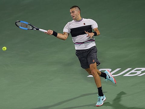Bona Coric of Croatia returns the ball to Tomas Berdych of Czech Republic during their match at the Dubai Duty Free Tennis Championship, in Dubai, United Arab Emirates, Wednesday, Feb. 27, 2019.