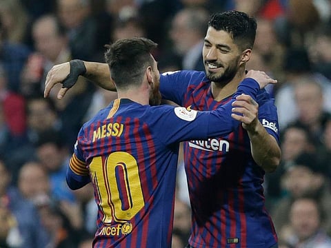 Barcelona forward Luis Suarez, right, celebrates with Lionel Messi.