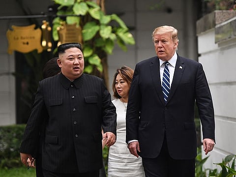 US President Donald Trump (R) walks with North Korea's leader Kim Jong Un during a break in talks at the second US-North Korea summit at the Sofitel Legend Metropole hotel in Hanoi on February 28, 2019. 