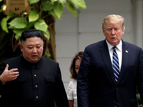 North Korea's leader Kim Jong Un and U.S. President Donald Trump talk in the garden of the Metropole hotel during the second North Korea-U.S. summit in Hanoi, Vietnam