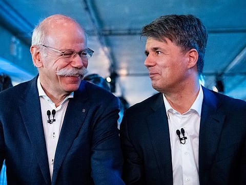 BMW CEO Harald Krueger, right, and Mercedes-Benz CEO Dieter Zetsche of Daimler, left, sit together at a press conference in Berlin, Germany, Friday