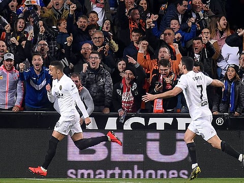 Valencia's Spanish forward Rodrigo Moreno (L) celebrates his goal.