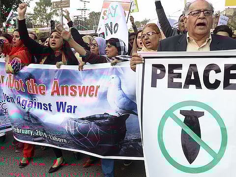 Pakistani civil society activists shout slogans as they march during a peace rally in Lahore on February 28, 2019. 