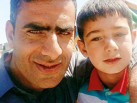 Naeem Raja, with his son, during his last visit home in Kashmir.
