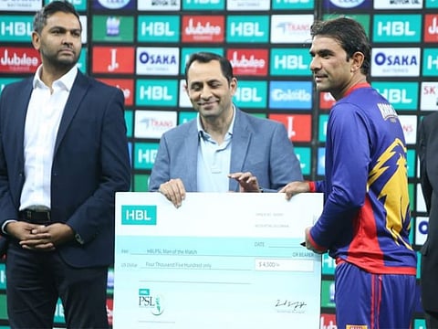 Iftikhar Ahmad receives the man of the match award.