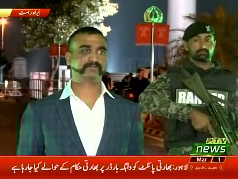 Indian pilot, Wing Commander Abhinandan, stands under armed escort near Pakistan-India border in Wagah, Pakistan in this March 1, 2019 image from a video footage.  
