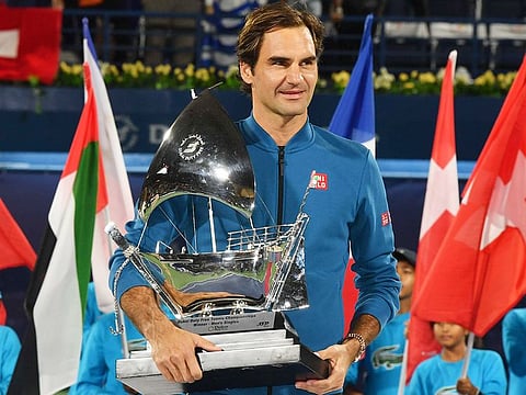 Roger Federer holds his trophy after winning the final match at the Dubai Duty Free Tennis Championship against Stefanos Tsitsipas of Greece, on Saturday, March 2, 2019. 