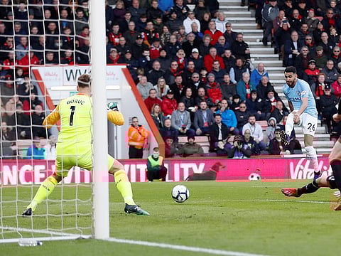 Manchester City's midfielder Riyad Mahrez scores the opening goal past Bournemouth's goalkeeper Artur Boruc (L) during the English Premier League football match between Bournemouth and Manchester City at the Vitality Stadium in Bournemouth, southern England on March 2, 2019. 