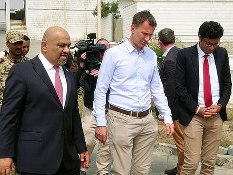 Yemen's Foreign Minister, Khaled Al Yamani, walks with British Foreign Secretary, Jeremy Hunt, at the presidential palace in Aden