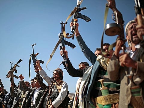 In this Dec. 13, 2018, file photo, tribesmen loyal to Houthi rebels hold up their weapons as they attend a gathering to show their support for the ongoing peace talks in Sanaa, Yemen.