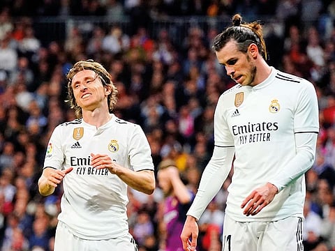 Real midfielder Luka Modric, left, and Real midfielder Gareth Bale react during the Spanish La Liga soccer match between Real Madrid and FC Barcelona at the Bernabeu stadium in Madrid, Saturday, March 2, 2019