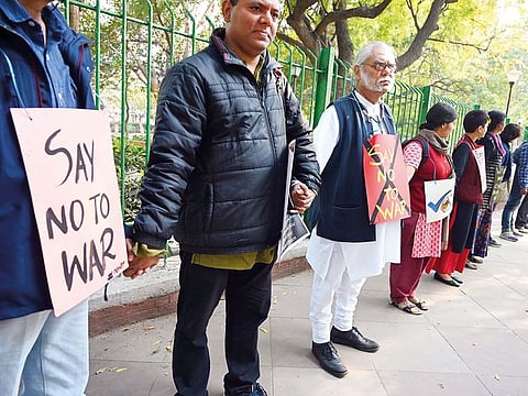 Demonstrators hold hands to form a human chain during an anti-war protest called by pacifist organisations in New Delhi. 