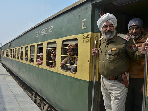 An Indian policeman and passengers from Pakistan look on from the Samjhauta Express train as it arrives in Atari, India. A Pakistani railway official said the key train service with neighboring India has resumed in another sign of easing tensions between the two nuclear-armed rivals since a major escalation last week over disputed Kashmir region.