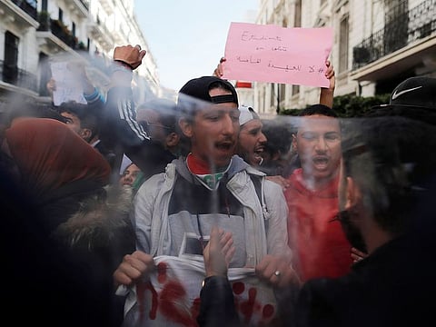 Students take part in a protest to denounce an offer by President Abdelaziz Bouteflika to run in elections next month but not to serve a full term if re-elected