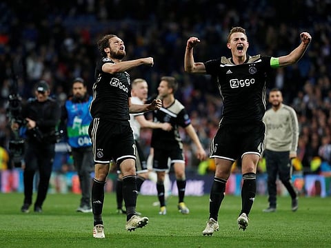 Ajax's Daley Blind and Matthijs de Ligt celebrate at the end of the match.