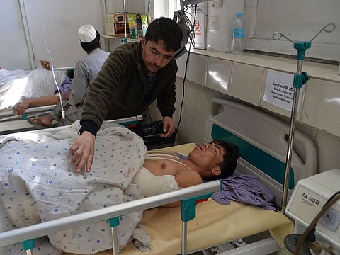 Afghan victims receive medical treatment at a hospital following a suicide attack on a private construction company in Jalalabad.