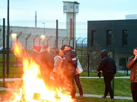 File photo: Waste burns as prison guards block the entrance to the penitentiary center of Alencon, in Conde-sur-Sarthe, northwestern France, on March 6, 2019, a day after a prison inmate seriously wounded two guards in a knife attack before being detained in a police raid. 