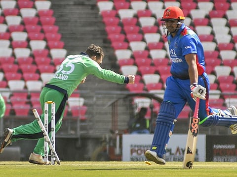 Hazratullah Zazai of Afghanistan is run out during the 3rd ODI cricket match against Ireland in Dehradun, on Tuesday. 