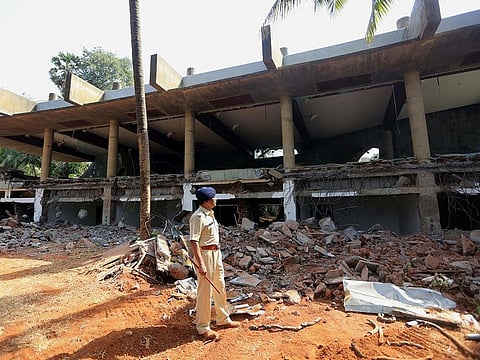 An Indian police officer stands near the remains of Nirav Modi's mansion in Alibaug, off Mumbai coast.