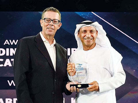 James Mullan, co-founder of Which Media, presents the award for Outstanding Contribution to Education to Abdullah Al Karam. 