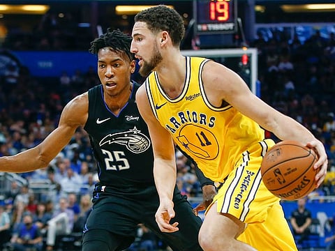 Golden State Warriors guard Klay Thompson (11) drives around Orlando Magic forward Wesley Iwundu (25) during the second quarter of an NBA basketball game in Orlando