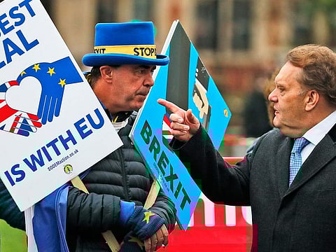 Protestors react as they demonstrate in front of the Houses of Parliament in London.