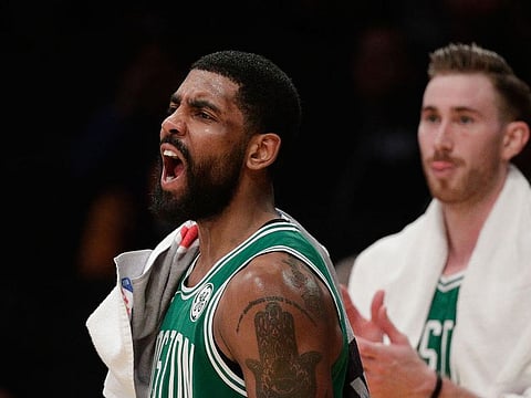 Boston Celtics' Kyrie Irving reacts to a basket made by his teammate during the second half of an NBA basketball game against the Los Angeles Lakers, Saturday, March 9, 2019, in Los Angeles