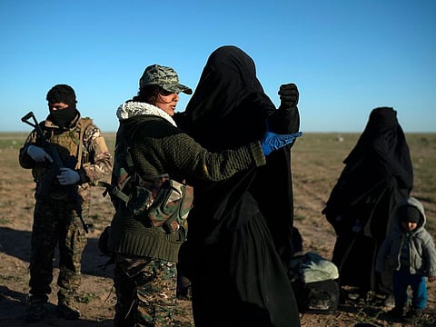 A woman is frisked by a US-backed Syrian Democratic Forces fighter at a screening area after being evacuated out of the last territory held by Daesh in the desert outside Baghouz, Syria. 