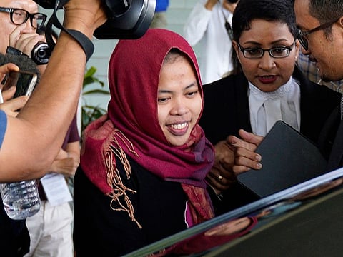 Indonesian Siti Aisyah, center, smiles as she leaves Shah Alam High Court in Shah Alam, Malaysia.