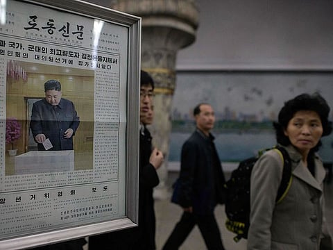 The Rodong Sinmun newspaper showing an image of North Korea's leader Kim Jong Un casting his ballot at the 14th Supreme People's Assembly elections is displayed at a subway station in Pyongyang on March 11, 2019.