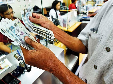 Filipino women sending money back home to support their families at UAE exchange branch in Satwa.
 A Filipino rights group in the UAE has launched an online petition to junk a controversial remittance draft law that would compel them to send money to their legal dependents or risk non-renewal of their passports.