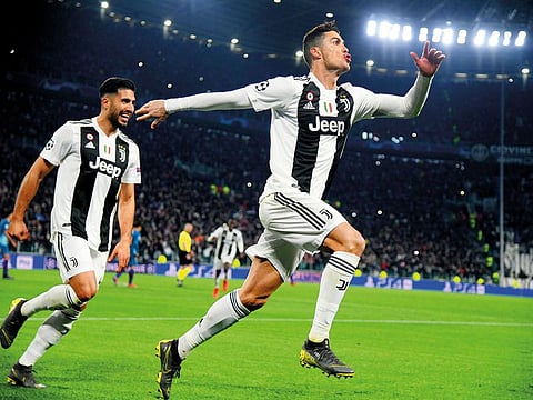 Juventus’ Cristiano Ronaldo celebrates with Emre Can after scoring their third goal.