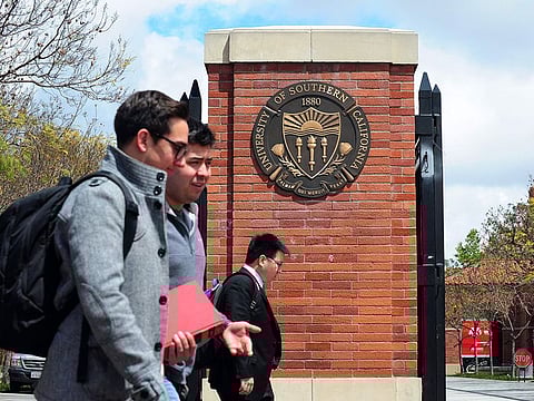 Students walk past an entrance to the University of Southern California (USC) in Los Angeles.