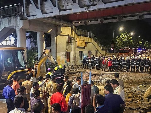 Rescue work in progress after a foot overbridge near a train station collapsed in south Mumbai.