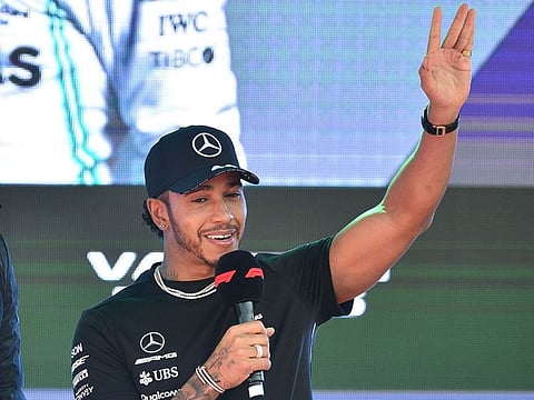 Mercedes' British driver Lewis Hamilton greet fans onstage during an F1 live event to introduce drivers and team principals in Melbourne on March 13, 2019, ahead of the Formula One Australian Grand Prix
