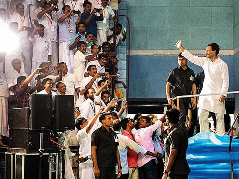 Congress President Rahul Gandhi waves at his supporters during an event to address 'fishermen's parliament', at Triprayar in Thrissur.