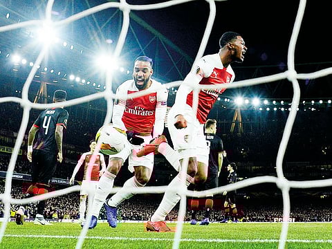 Arsenal's Ainsley Maitland-Niles celebrates scoring their second goal.