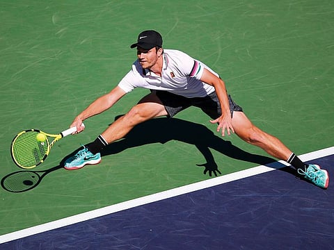 Miomir Kecmanovic of Serbia plays a forehand against Milos Raonic of Canada during their men's singles quarterfinal match at the BNP Paribas Open at the Indian Wells Tennis Garden on March 14, 2019 in Indian Wells, California.