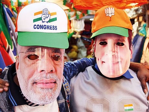 Masks of Narendra Modi and Rahul Gandhi on sale on the pavement shops in Delhi.