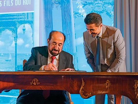  Dr Shaikh Sultan signs a copy of his book Bibi Fatima and The King’s Sons in Paris.