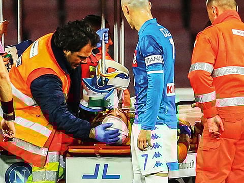 Napoli's Colombian goalkeeper David Ospina (C) is evacuated after sustaining a head injury during the Italian Serie A football match Napoli vs Udinese at the San Paolo stadium in Naples