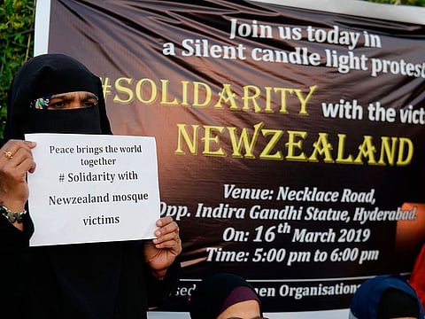 Indian muslim woman holds a placard during a silent protest to pay tribute to the victims of the March 15 Christchurch mosques attacks, in Hyderabad on March 16, 2019.